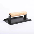 Black metal tool with a wooden handle on a white background