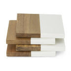 Stack of wooden and white cutting boards on a white background