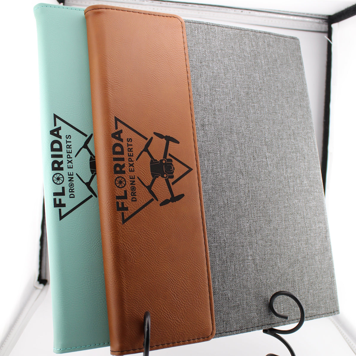 Notebook with leather cover and 'Florida Drone Experts' branding on a white background