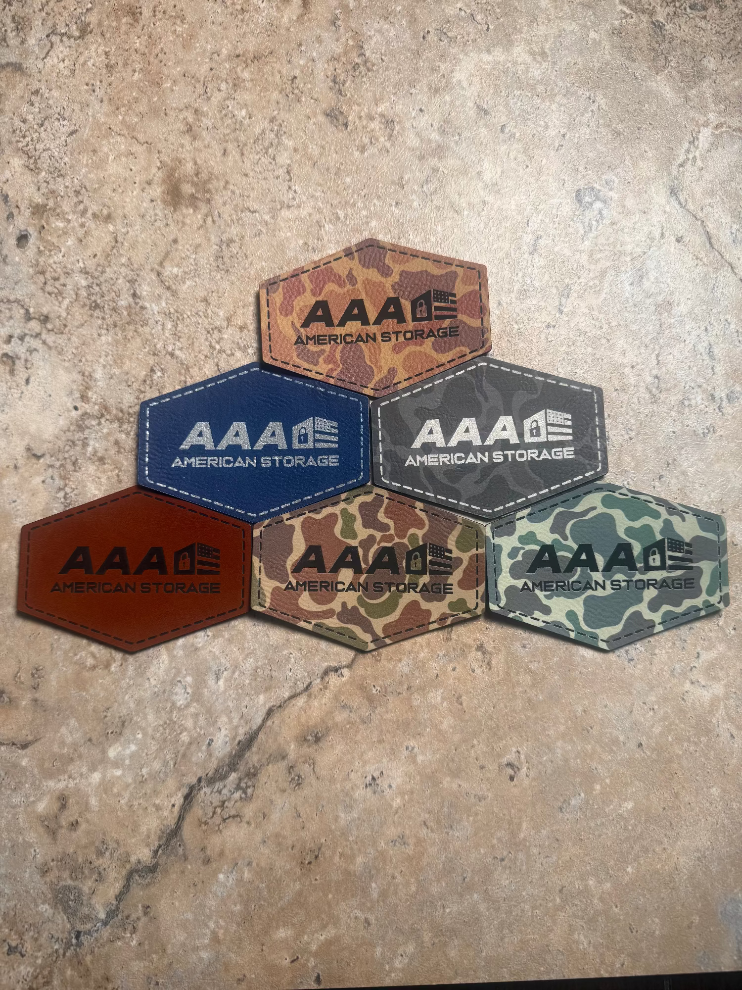 Hexagonal patches with 'AAA American Storage' logo on a textured surface