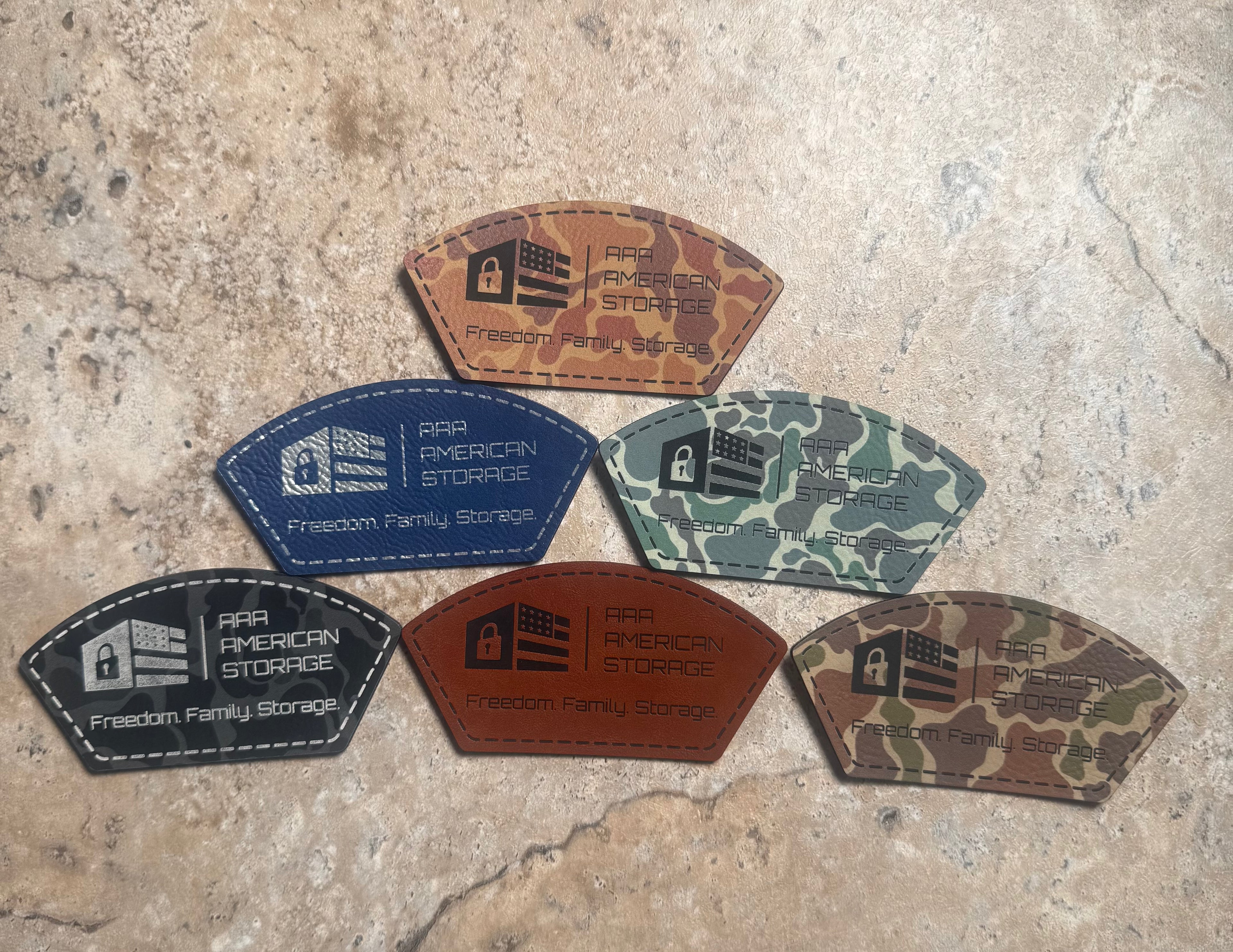 Set of six leather patches with 'American Freedom Storage' logo on a textured surface