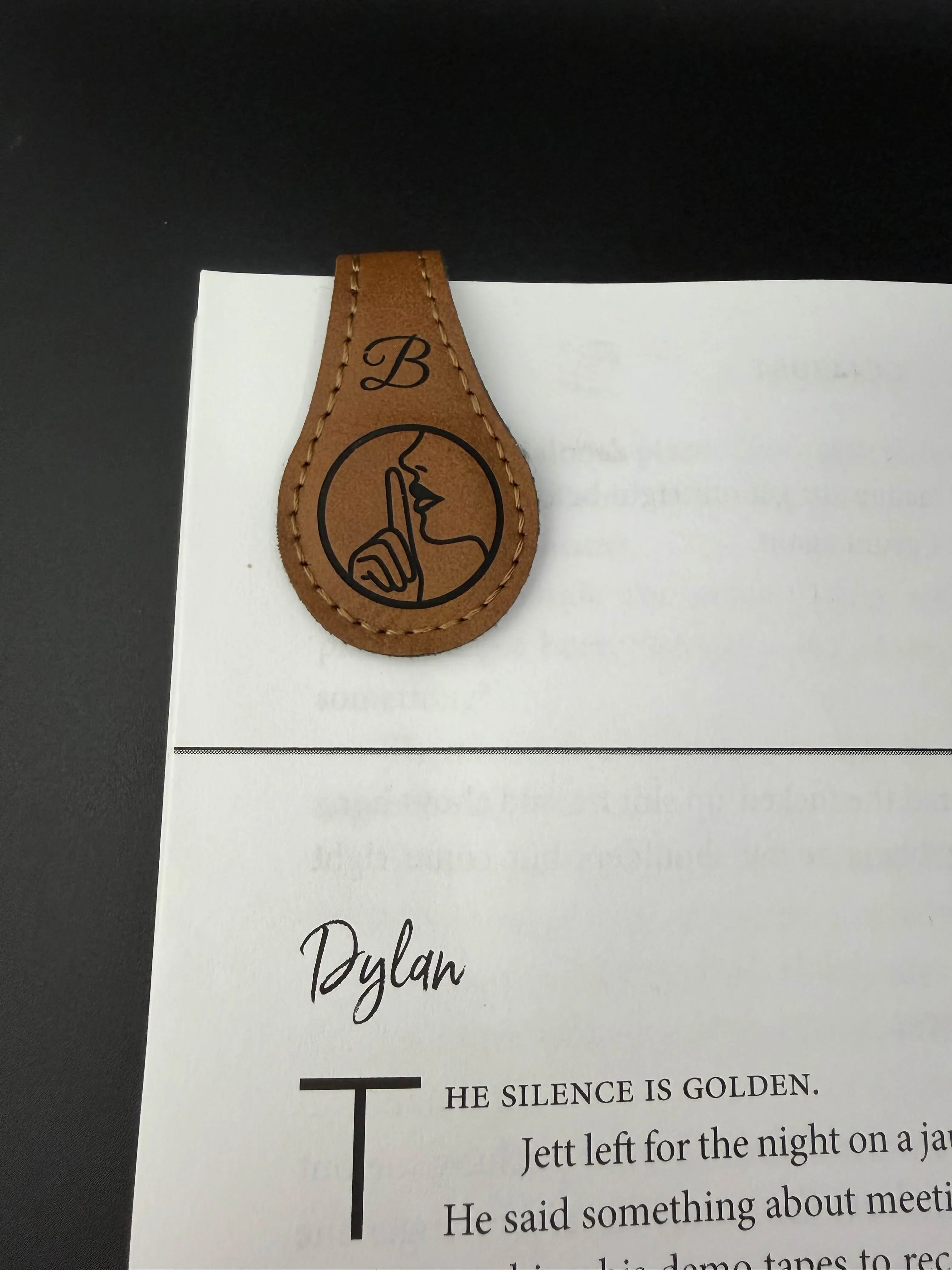 Leather tag with a symbol and text on a book