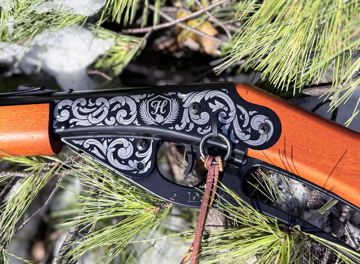 Decorative crossbow with intricate engravings on a natural background