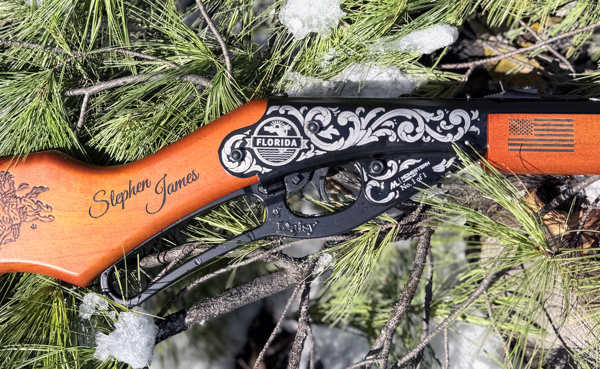 Wooden bow with decorative design and 'Florida' branding, leaning against a tree with snow on branches.