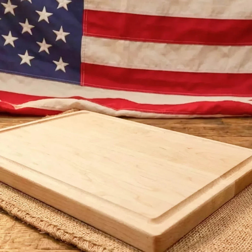 Wooden cutting board on a woven surface with an American flag in the background