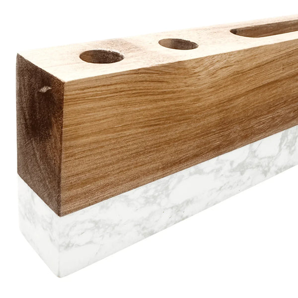 Wooden block with three holes on a white background