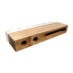 Wooden block with three holes on a white background