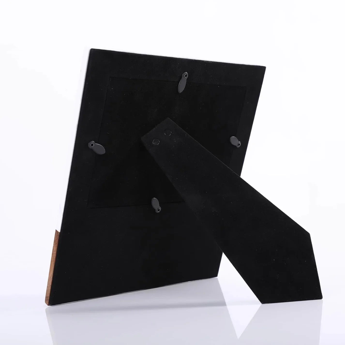 Black suede shoes with wooden soles on a white background