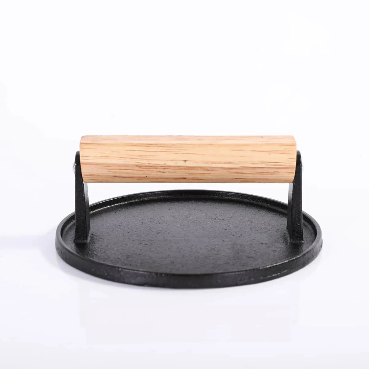 Cast iron tortilla press with wooden handle on a white background