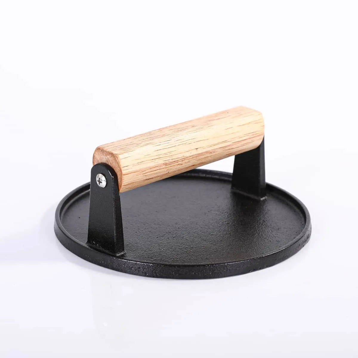 Black metal tortilla press with a wooden handle on a white background