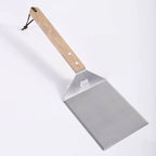 Metal spatula with wooden handle on a white background