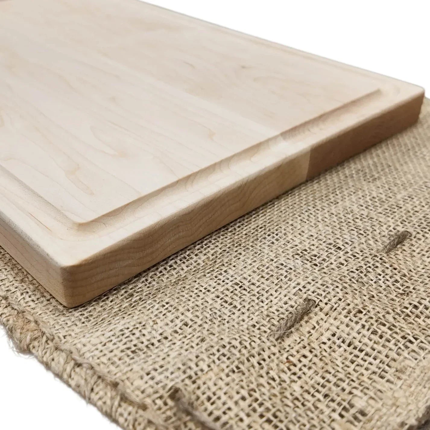 Wooden cutting board on a textured fabric background