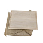 Wooden cutting board on a burlap cloth with a white background